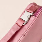 Close-up of Nom insulated lunch bag adjustable shoulder strap and buckle detail in Pink
